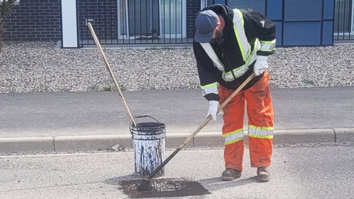 City of Lethbridge road maintenance crews repair potholes. (Photo by Stan Ashbee)