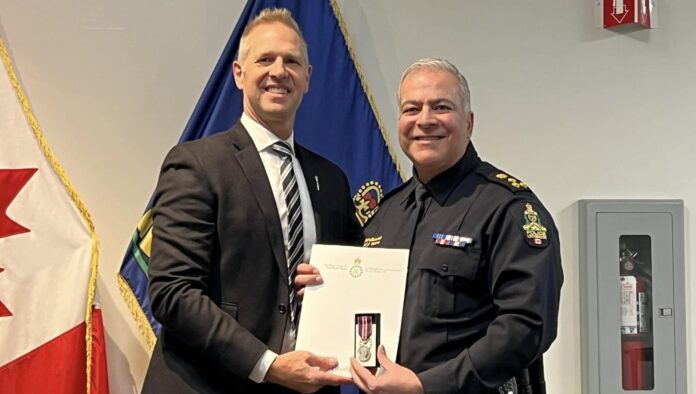 Lethbridge East MLA Nathan Neudorf presenting Chief Shahin Mehdizadeh with the King Charles III Coronation Medal