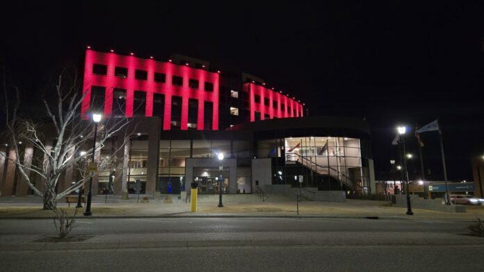 Lethbridge City Hall seen lit up in red for Multiple Myeloma Awareness Month, March 11, 2025. (Photo: J. Goulet, My Lethbridge Now)