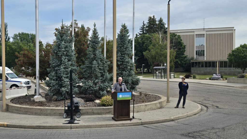 Dr. Brad Donaldson speaks at the flag raising on June 25, 2025, alongside Adrianna Smith. (Photo: J. Goulet, My Lethbridge Now)