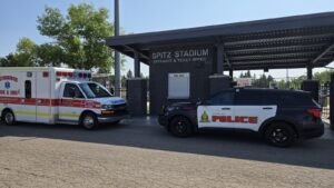 An LFES ambulance and LPS vehicle parked outside Spitz Stadium, June 17, 2025. (Photo: J. Goulet, My Lethbridge Now)