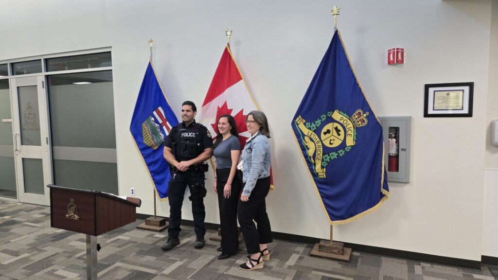 L to R: LPS Constable Chris Andrade alongside Safer Communities Educators Ashley Killins and Brandee Brown, June 23, 2025. (Photo: J. Goulet, My Lethbridge Now)